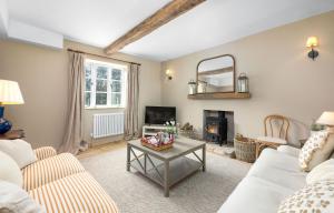 a living room with a couch and a table at Fernhalls Mill in Munslow