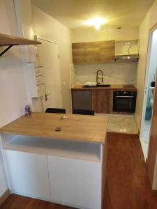 a small kitchen with a wooden counter top at Small modern air-conditioned cocoon in Châteauroux