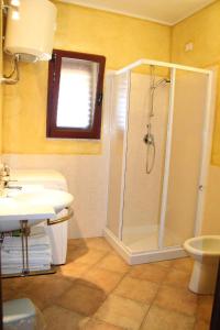 a bathroom with a shower and a sink at New Orange Studio 9 in Budoni +14 photos