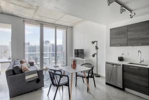 a kitchen and living room with a couch and a table at High Floor Pool Gym Brickell in Miami