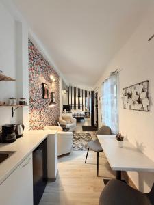 a kitchen and living room with a couch and a table at Alandala by The Center in Cluj-Napoca