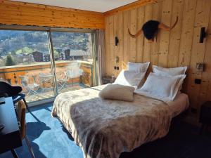 a bedroom with a bed with a cat on the wall at Hôtel Le Labrador 1971 in Les Gets +139 photos