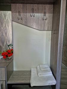 a cabinet with two folded towels in a room at One-Bedroom Apartment in Fergana