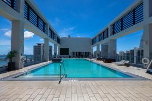 a large swimming pool on the roof of a building at High Floor Pool Gym Brickell in Miami +10 photos