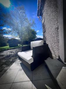 a couch sitting on the side of a building at The Nook at Ballyward Croft in Ardkeen +13 photos