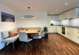 a kitchen and dining room with a table and chairs at Ferienwohnung Hingucker in Tschagguns
