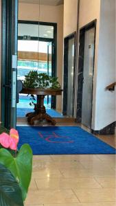 a room with a table and a blue rug at Hotel Cristallo in Udine