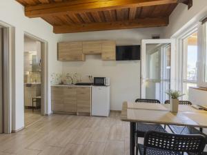a kitchen and dining room with a table and chairs at Apartment Lena 2 by Interhome in Balatonberény