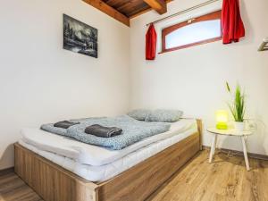 a bed in a room with a window and a table at Apartment Lena 2 by Interhome in Balatonberény