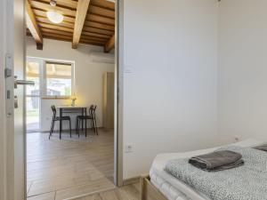 a bedroom with a bed and a table with chairs at Apartment Lena 2 by Interhome in Balatonberény