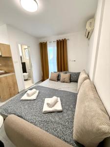 a living room with a couch with towels on it at Vila Lavandel in Bečići +18 photos