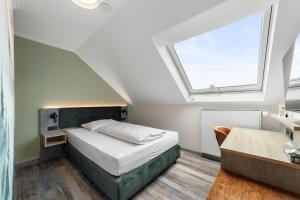 a bedroom with a bed and a window at Hotel Franken in Forchheim +46 photos