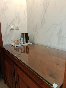 a counter in a room with a marble wall at Grand Hôtel City - Akwa in Douala +21 photos