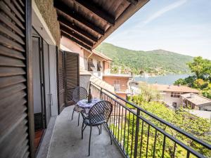 a balcony with two chairs and a table on it at Holiday Home Iside by Interhome in Mergozzo