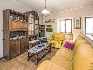 a living room with a couch and a table at Holiday Home Iside by Interhome in Mergozzo