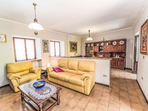 a living room with two couches and a table at Holiday Home Iside by Interhome in Mergozzo