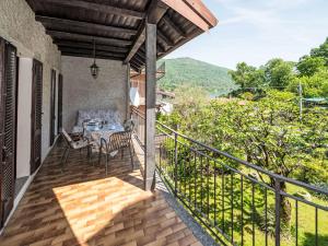a balcony of a house with a table and chairs at Holiday Home Iside by Interhome in Mergozzo