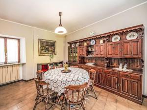 a dining room with a table and wooden cabinets at Holiday Home Iside by Interhome in Mergozzo +25 photos