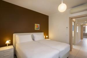 a bedroom with a large white bed with two lamps at Cà Gardesana With Pool in Garda +29 photos