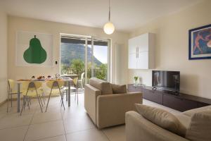 a living room with a couch and a table at Cà Gardesana With Pool in Garda