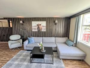 a living room with a couch and a table at Apartment Floren by Interhome in Herand