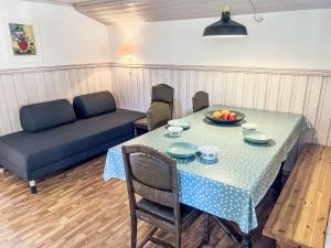 a living room with a table and a couch at Apartment Floren by Interhome in Herand