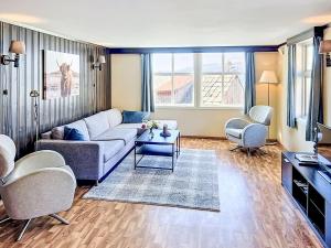 a living room with a couch and a table at Apartment Floren by Interhome in Herand +32 photos