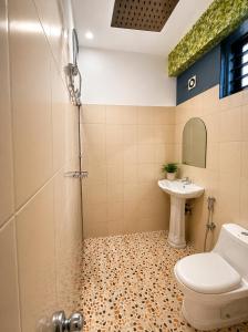 a bathroom with a shower and a toilet and a sink at Courtyard Residency Thekkady in Thekkady