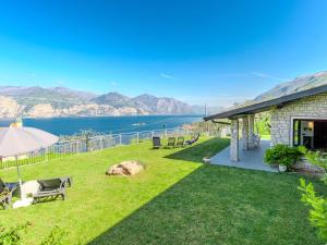 a backyard with a view of the water at Villa Manuela by Interhome in Brenzone sul Garda