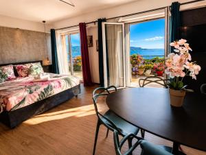 a bedroom with a table and a bed and a window at Open Space Mi Alma Lake View in Toscolano Maderno