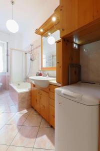 a bathroom with a sink and a washing machine at PrimoPiano - Padova 256 in Milan +34 photos