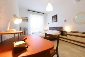 a hotel room with a bed and a table and a desk at PrimoPiano - Padova 256 in Milan