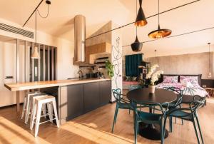a kitchen and dining room with a table and chairs at Open Space Mi Alma Lake View in Toscolano Maderno