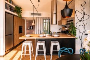 a kitchen with a island with bar stools at Open Space Mi Alma Lake View in Toscolano Maderno +23 photos