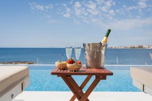 a table with a bottle of wine and fruit on a patio at Villa Giada Luxury Boutique Hotel in Civitavecchia +192 photos