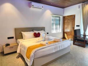 a bedroom with a large bed in a room at Coorg Tiger Eye Backwater Resort in Kushālnagar +62 photos