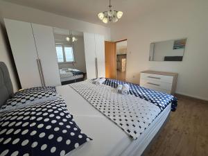a bedroom with a large bed with black and white pillows at Apartman Helena in Senj