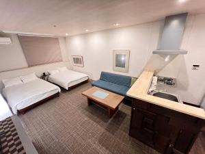 a room with two beds and a sink and a couch at 内町2階 1フロアまるごと貸切 高松中心部 4名まで in Takamatsu +17 photos