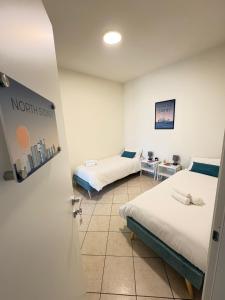 a room with two beds and a door open at Sydney Apartment in Frosinone