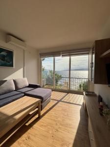 a bedroom with a bed and a view of the ocean at Apartman Helena in Senj