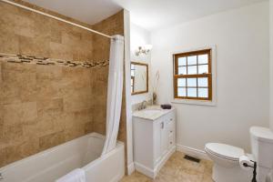 a bathroom with a tub and a sink and a toilet at 58 River Rd. East in Wasaga Beach +12 photos