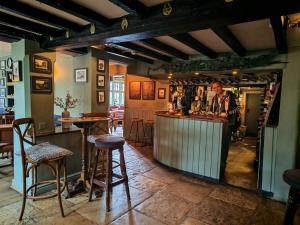 a man standing at a bar in a pub at The Windmill Inn in Horsham
