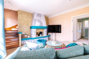 a living room with a couch and a fireplace at L'Escale - Maison 5CH & Jardin in Bray-Dunes +31 photos
