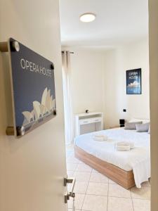 a bedroom with a bed and a sign on the door at Sydney Apartment in Frosinone