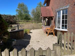 a backyard with a wooden fence and a chair at Pinecroft B&B in Lymington