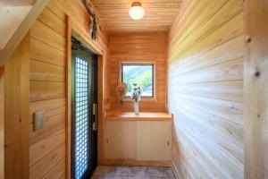 a hallway of a wooden house with a window at 結の里 in Gero +58 photos