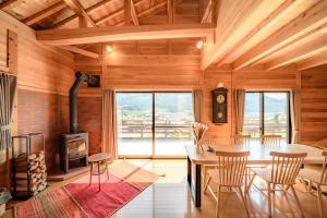 a kitchen and dining room with a table and a stove at 結の里 in Gero