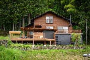 a wooden house with a garage at 結の里 in Gero