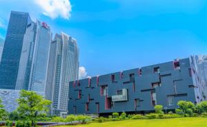 a building in a city with tall buildings at BangTai International Aparthotel-3min walk to Line 8 Modiesha Subway STN-20min to Pazhou Exhibition Center in Guangzhou