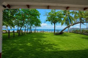 a park with trees and the ocean in the background at Casa Osú in Sámara +3 photos